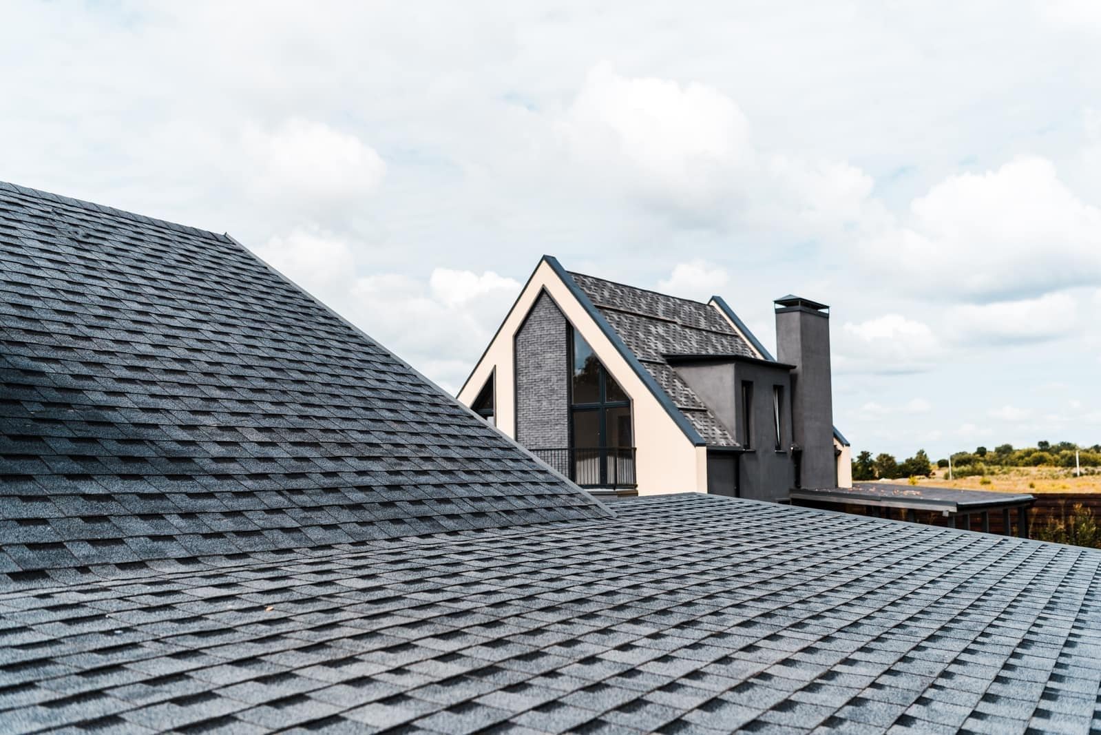 Architectural asphalt shingle roof covering a steep residential roof slope